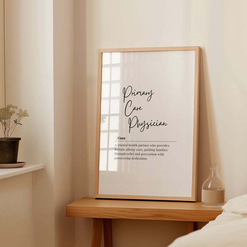 Elegant minimalist typography print defining 'Primary Care Physician' in black script font on white background, featuring serif 'Noun' detail and clean professional layout in simple wooden frame.