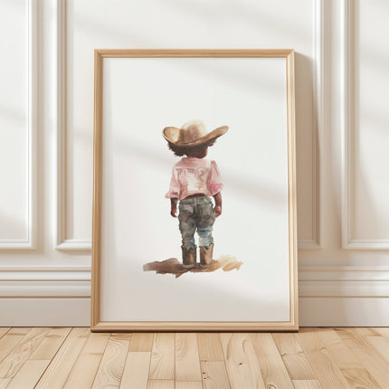 Watercolor illustration of small child in cowboy hat and boots, wearing pink shirt and blue jeans against white background, with soft nostalgic colors creating a peaceful, whimsical western nursery aesthetic.
