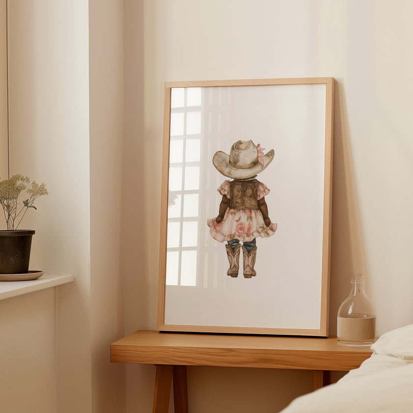 Whimsical illustration of young girl wearing cowboy hat, pink floral dress and boots against white background, creating a soft botanical aesthetic perfect for nursery or children's room decor.