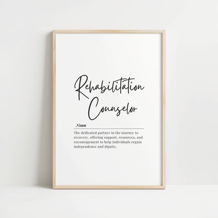 Modern typography print with 'Rehabilitation Counselor' definition in bold black script against white background, framed in warm wood, creating a professional yet inspiring atmosphere for therapy spaces.