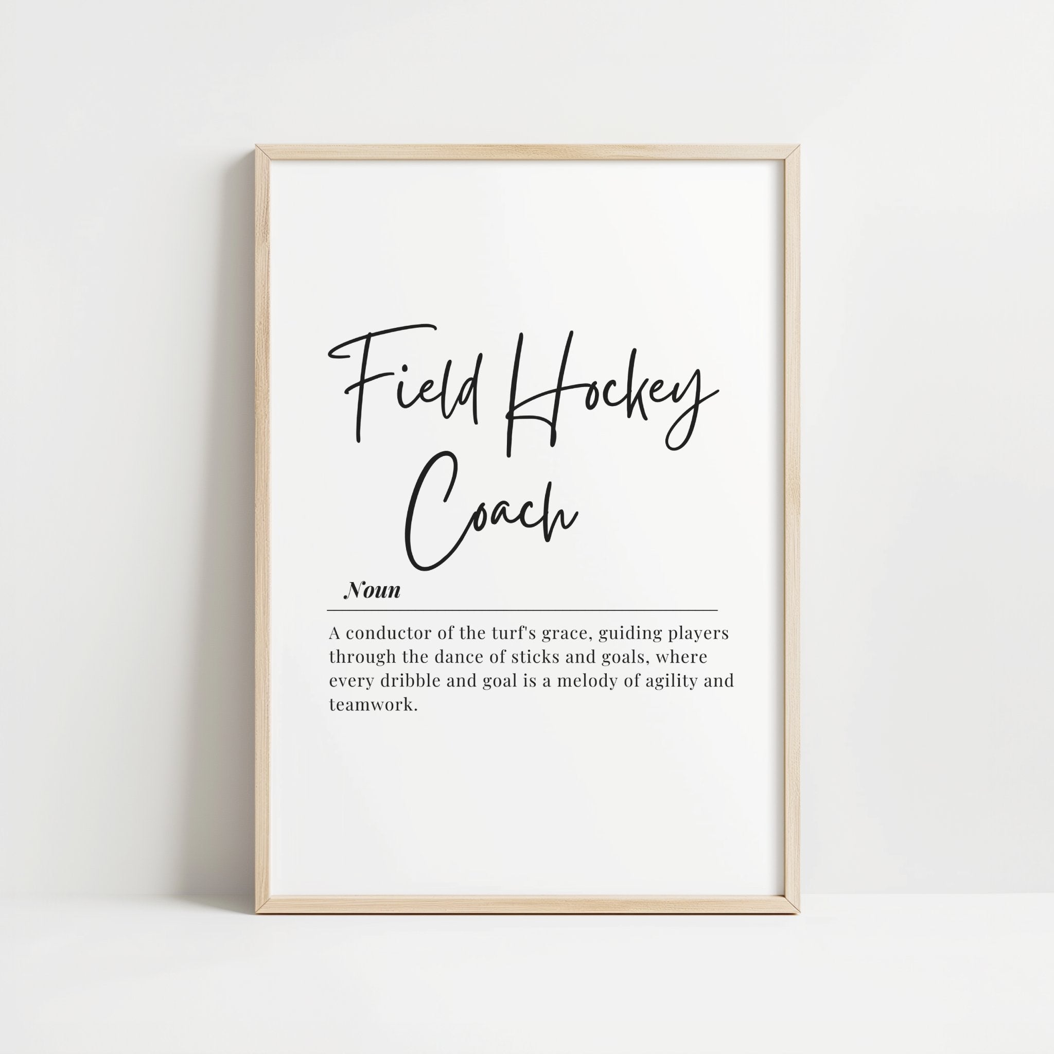 Elegant field hockey coach definition typography print featuring black script and serif fonts on white background, blending motivational quote with minimalist design for professional sports environments.