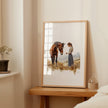Serene vintage print of girl with horse in warm earth tones and sage greens, showcasing gentle interaction against white background with rustic wooden frame for farmhouse living spaces.