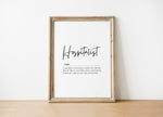 Minimalist typographic design featuring 'Hospitalist' in bold script against a white background with an elegant definition below, framed in natural wood for a calming professional environment.