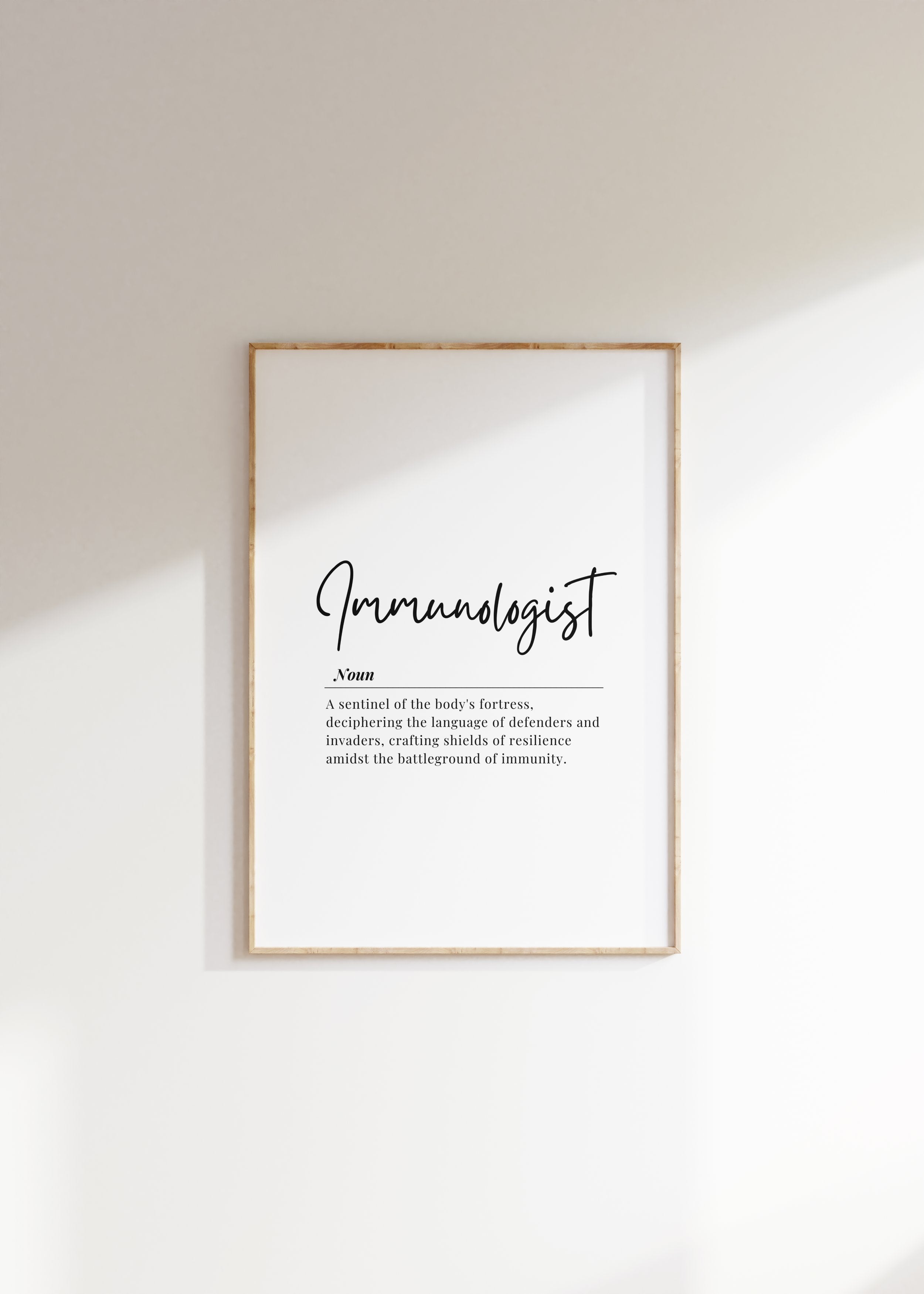 Modern typography print featuring 'Immunologist' in elegant black script with a poetic definition against a clean white background, framed in natural wood for professional medical spaces.