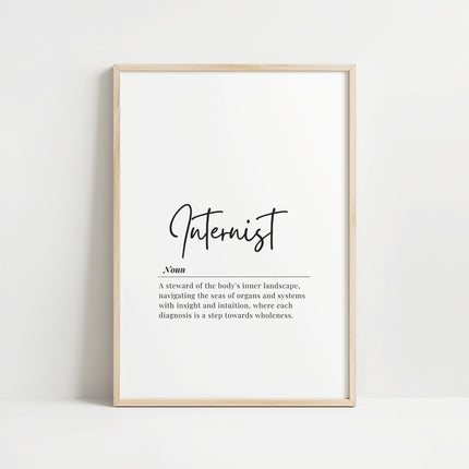 Minimalist typography print featuring 'Internist' in bold sans-serif font with an elegant definition beneath on white background with wood frame, creating a sophisticated professional aesthetic.