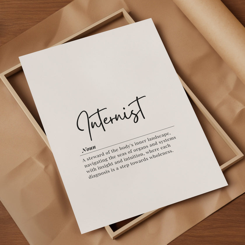 Minimalist typography print featuring 'Internist' in bold sans-serif font with an elegant definition beneath on white background with wood frame, creating a sophisticated professional aesthetic.
