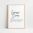 Minimalist black script typography displaying 'Lacrosse Coach' definition against white background, framed in natural wood, perfect for athletic environments and modern office spaces.
