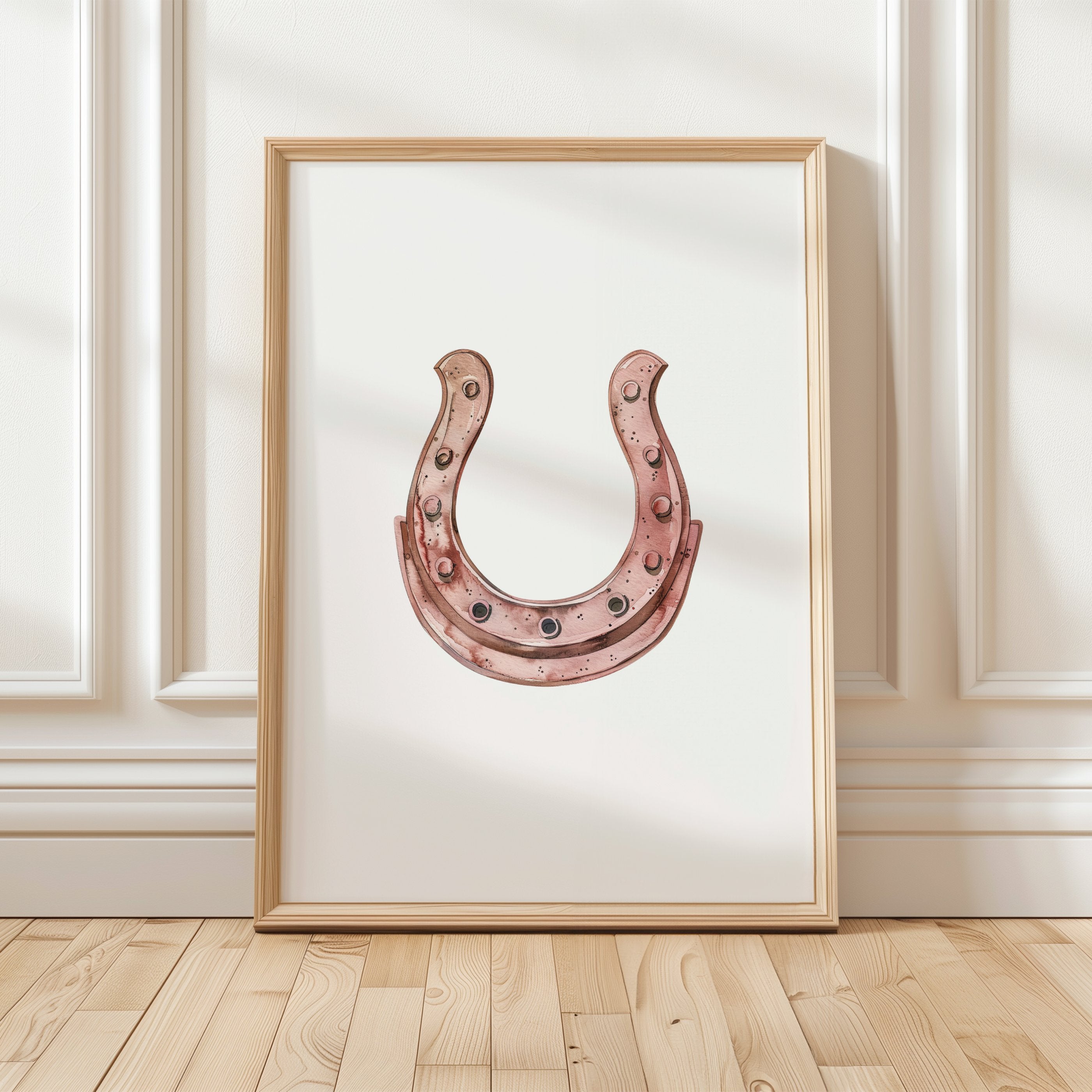 Minimalist copper horseshoe against white background in rustic frame, conveying warmth and protection through simple, elegant design perfect for farmhouse or Scandinavian decor.