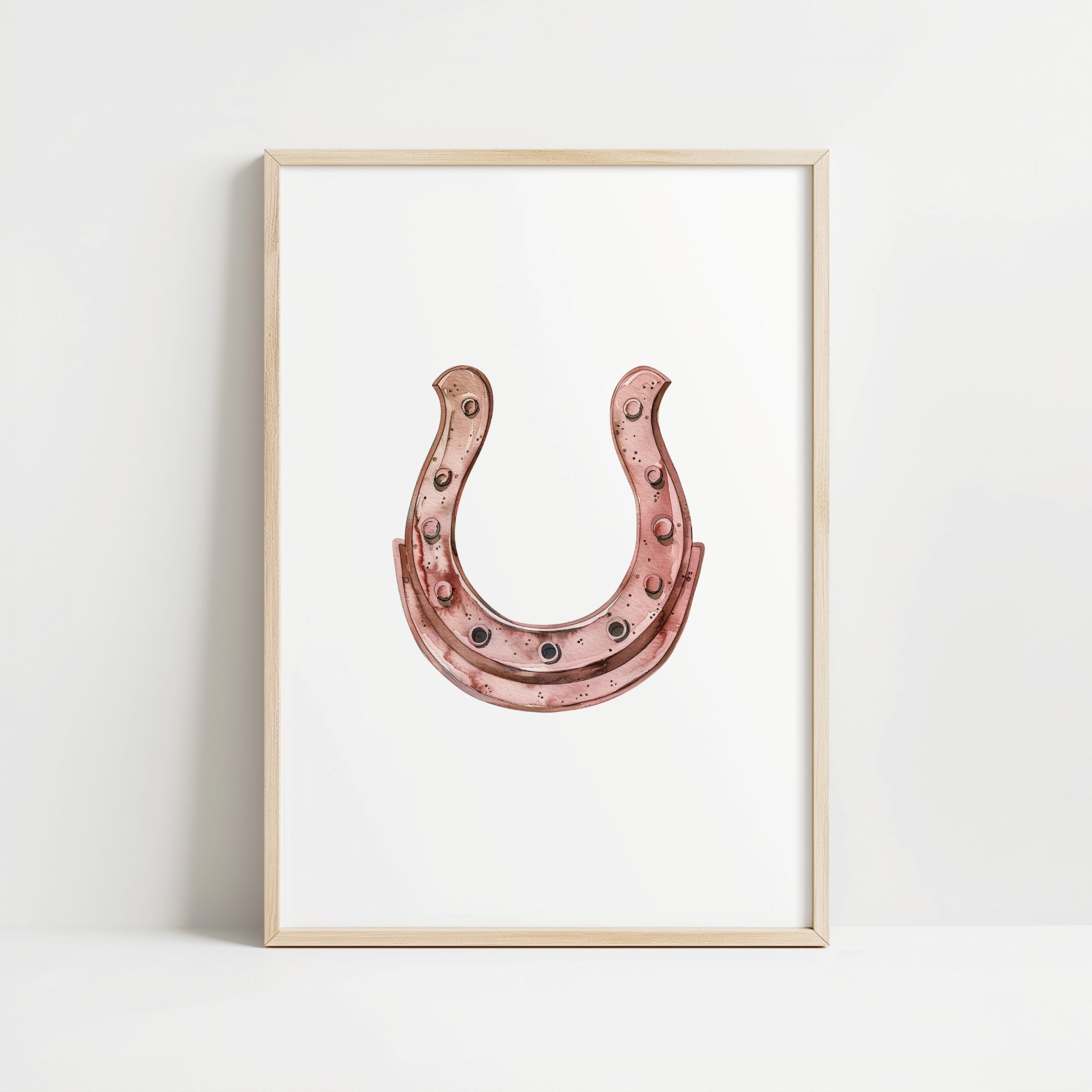 Minimalist copper horseshoe against white background in rustic frame, conveying warmth and protection through simple, elegant design perfect for farmhouse or Scandinavian decor.