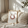 Minimalist copper horseshoe against white background in rustic frame, conveying warmth and protection through simple, elegant design perfect for farmhouse or Scandinavian decor.