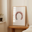 Minimalist vintage horseshoe print in warm copper tones against crisp white background, featuring rustic texturing and simple composition perfect for farmhouse and Scandinavian decor