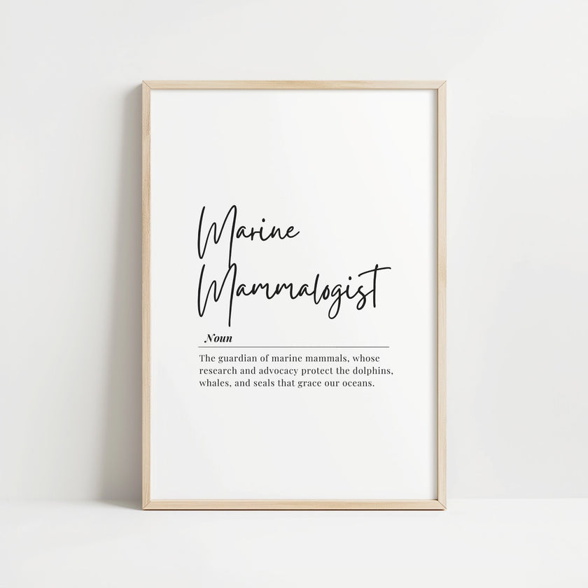 Minimalist typography print featuring 'Marine Mammalogist' in elegant black script with serif definition text against white background, framed in oak, celebrating ocean conservation professionals.
