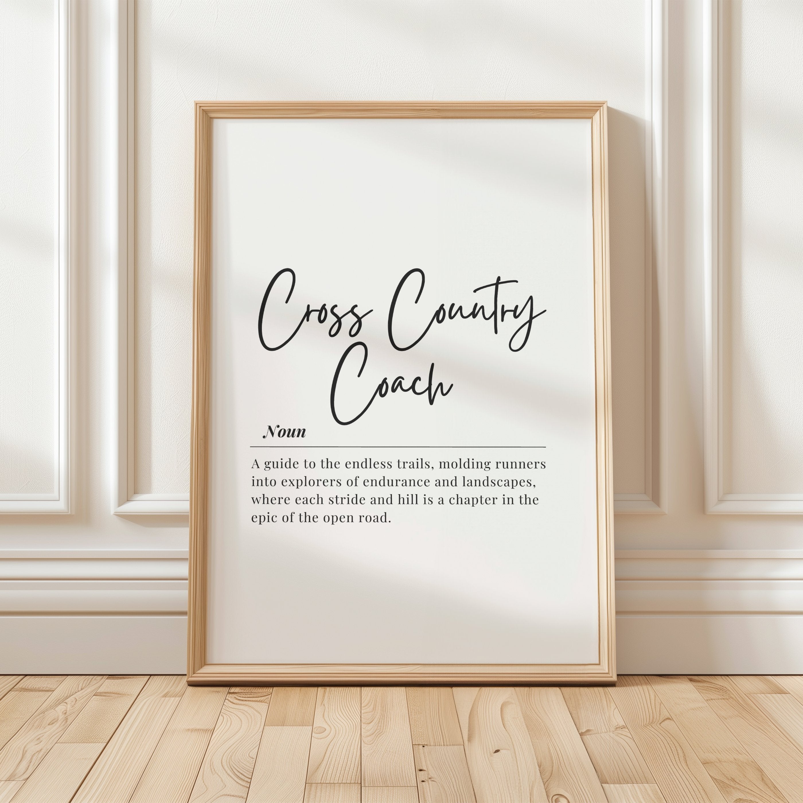 Minimalist black typography print featuring 'Cross Country Coach' definition in elegant script and serif fonts against white background, conveying motivation for athletic environments.
