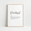 Elegant black script 'Paleontologist' on white background with definition text describing fossil seekers, framed in light wood, perfect for academic or home office spaces