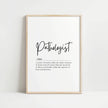 Modern black and white typography print featuring the Pathologist definition in elegant script against a clean white background, framed in wood for a professional medical office aesthetic.