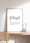 Modern black and white typography print featuring the Pathologist definition in elegant script against a clean white background, framed in wood for a professional medical office aesthetic.