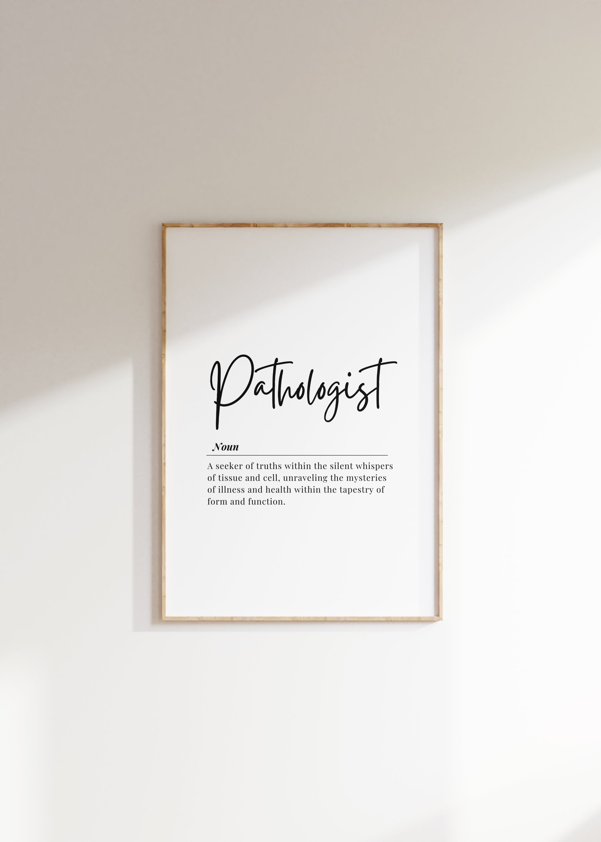Modern black and white typography print featuring the Pathologist definition in elegant script against a clean white background, framed in wood for a professional medical office aesthetic.
