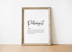 Modern black and white typography print featuring the Pathologist definition in elegant script against a clean white background, framed in wood for a professional medical office aesthetic.