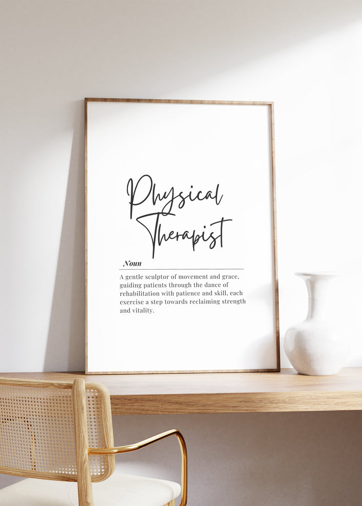 Minimalist black and white physical therapist definition print with bold script title and serif font text, showcasing professional typography against clean white background in natural wood frame.