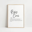 Modern typography print with 'Rugby Coach' in flowing script against white background, featuring inspirational definition about orchestrating the physical ballet of rugby, framed in natural wood.