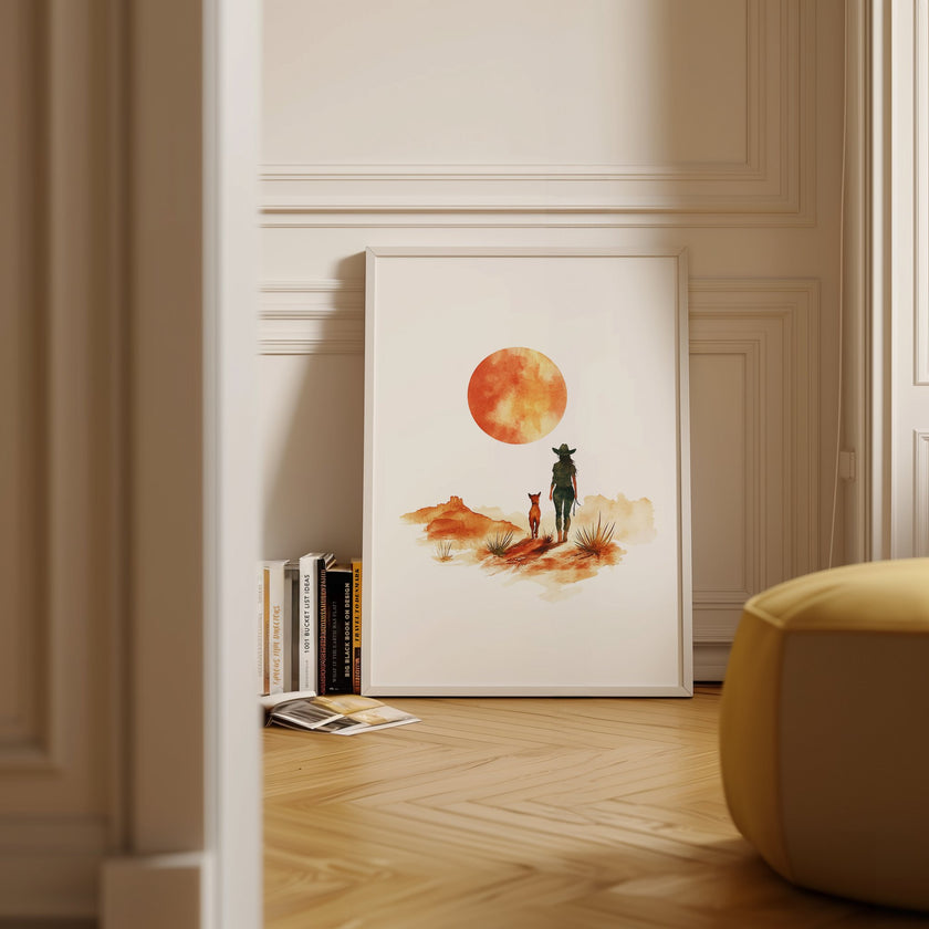 Minimalist watercolor print featuring silhouettes of a person and dog against a vivid burnt orange sunset in a desert landscape, conveying serenity and adventure in warm earthy tones.