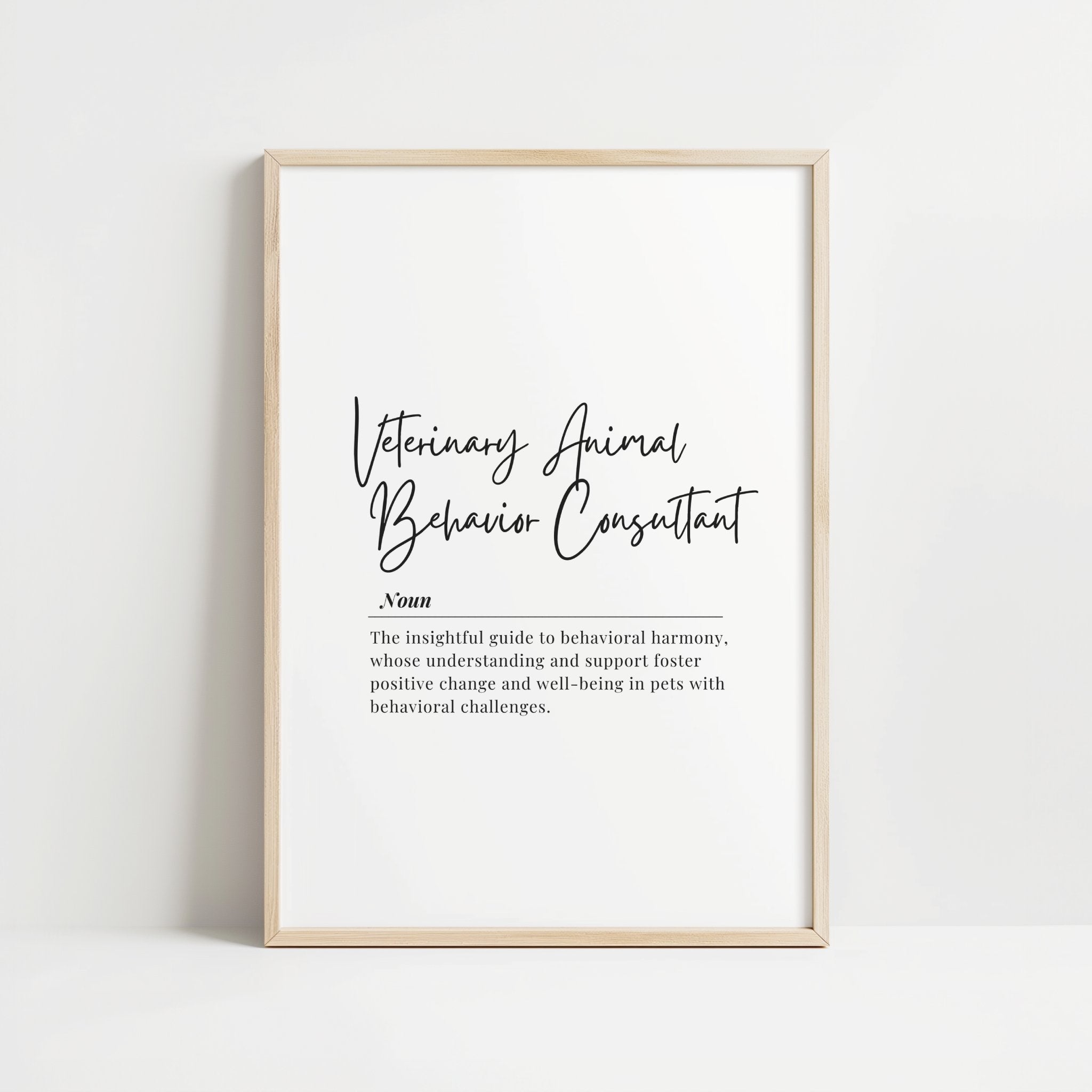 Elegant black script 'Veterinary Animal Behavior Consultant' with inspirational definition against white background in wooden frame, creating a sophisticated professional tribute to animal behavior specialists.