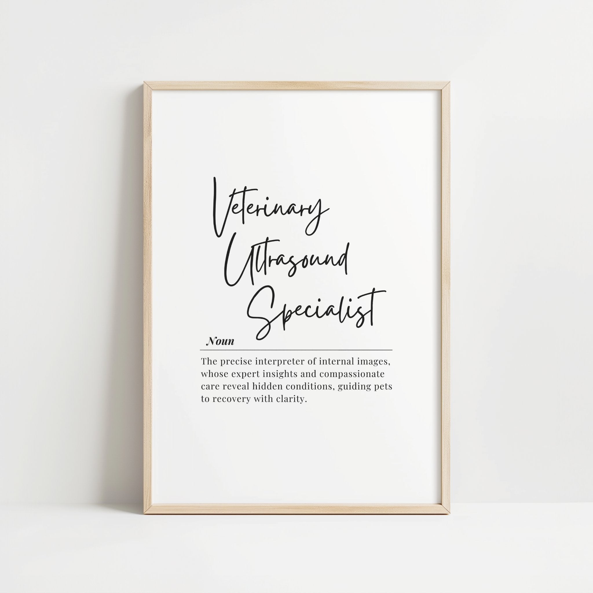 Modern typography print featuring 'Veterinary Ultrasound Specialist' in elegant script with serif explanatory text on white background, framed in clean wood, conveying professional sophistication for clinical settings.