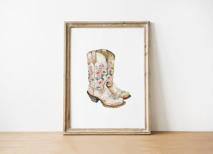 Delicate watercolor cowboy boots with intricate floral patterns in soft blush pink, cream and sage green against white background, creating whimsical rustic charm for farmhouse decor
