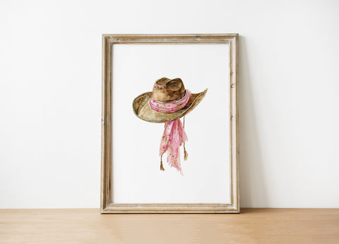 Delicate watercolor cowgirl hat with soft pink floral scarf against white background, featuring gentle brushstrokes and earthy tones perfect for rustic farmhouse decor.