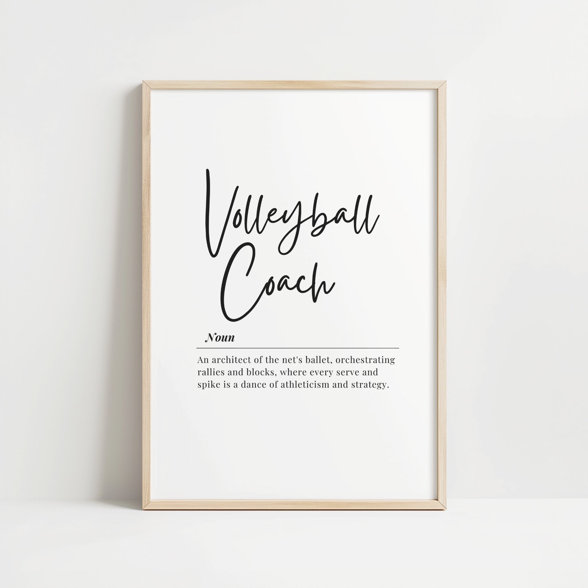 Elegant minimalist typography print featuring 'Volleyball Coach' in black cursive script on white background with inspirational definition text in serif font, presented in a sleek wooden frame.