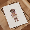 Whimsical watercolor cowgirl illustration in earthy browns, soft pinks, and cream, featuring intricately designed cowboy hat and boots with delicate floral accents, perfect for country-themed nurseries.