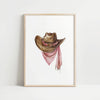 Rustic watercolor cowboy hat with pink polka dot bandana against white background, featuring detailed brushstrokes and soft muted colors perfect for farmhouse and western-themed spaces.