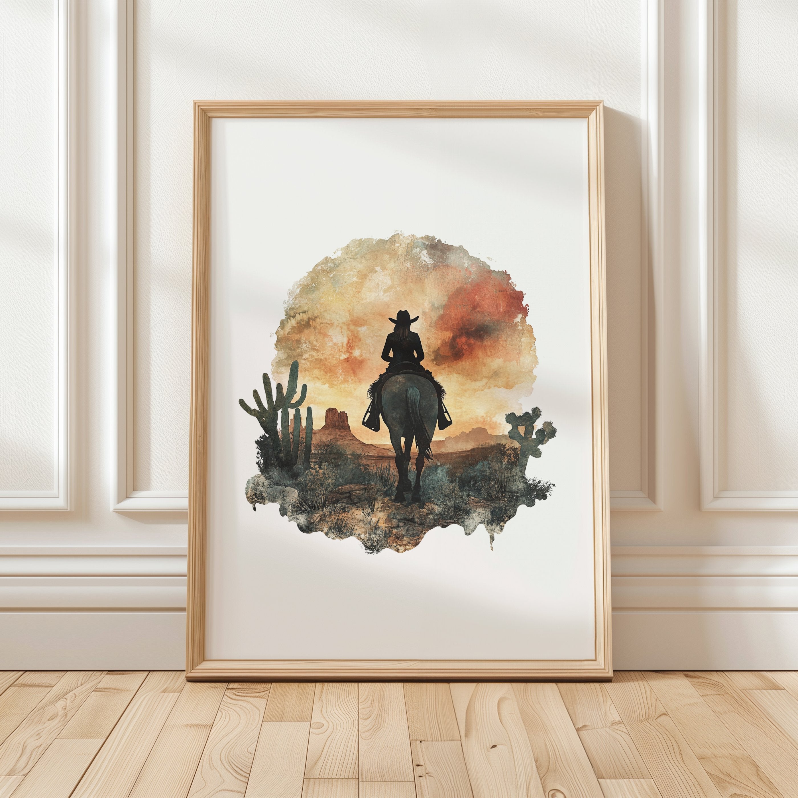 Watercolor silhouette of a cowboy on horseback against desert sunset hues of russet and ochre, framed by cacti with textured white space creating nostalgic, adventurous atmosphere.