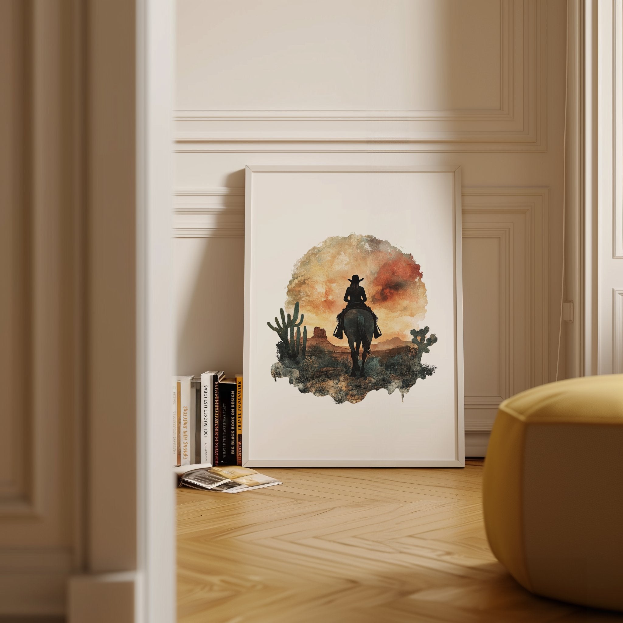 Watercolor silhouette of a cowboy on horseback against desert sunset hues of russet and ochre, framed by cacti with textured white space creating nostalgic, adventurous atmosphere.