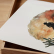 Watercolor silhouette of a cowboy on horseback against desert sunset hues of russet and ochre, framed by cacti with textured white space creating nostalgic, adventurous atmosphere.