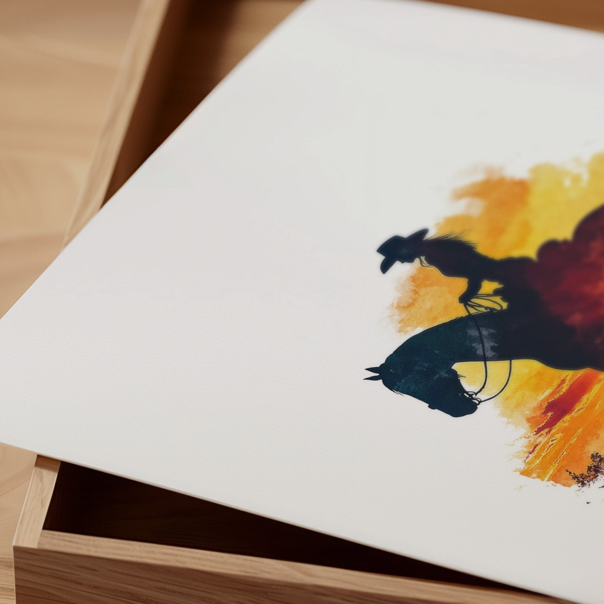 Dramatic silhouette of cowboy on horseback against vibrant orange, red and yellow sunset, featuring textured watercolor splashes creating a nostalgic, adventurous western landscape perfect for rustic decor.