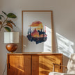 Silhouetted cowboy on horseback against vibrant orange and red sunset with navy blue mountains, cacti and desert formations creating a powerful rustic southwestern aesthetic.