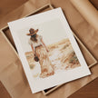 Serene vintage illustration of a solitary woman in wide-brimmed hat walking through desert landscape, rendered in soft sepia tones and sandy beige with minimalist sage green accents.