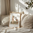 Vintage illustration of a girl in floral dress with gentle deer and bird in wildflower meadow, using earthy sienna and sage tones on white background
