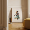 Watercolor cowgirl drawing a revolver in teal, sand, and cinnamon tones against white background, conveying motion and independence with flowing skirt and hat, perfect for modern farmhouse decor.