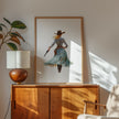 Watercolor cowgirl drawing a revolver in teal, sand, and cinnamon tones against white background, conveying motion and independence with flowing skirt and hat, perfect for modern farmhouse decor.