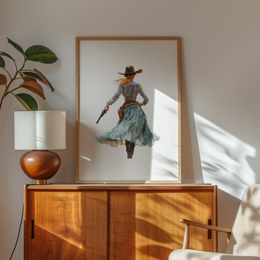 Watercolor cowgirl drawing a revolver in teal, sand, and cinnamon tones against white background, conveying motion and independence with flowing skirt and hat, perfect for modern farmhouse decor.