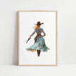 Watercolor cowgirl drawing a revolver in teal, sand, and cinnamon tones against white background, conveying motion and independence with flowing skirt and hat, perfect for modern farmhouse decor.