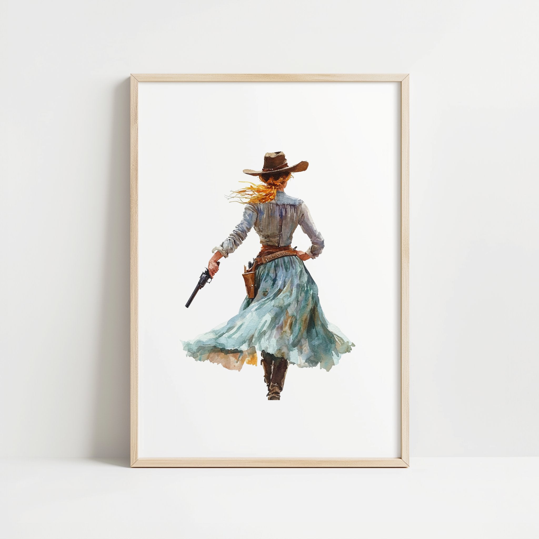 Watercolor cowgirl drawing a revolver in teal, sand, and cinnamon tones against white background, conveying motion and independence with flowing skirt and hat, perfect for modern farmhouse decor.