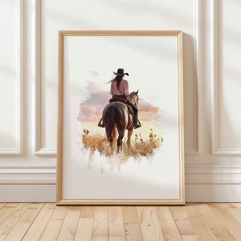 Watercolor cowgirl riding horse at sunset with soft pastel tones of blush pink, amber and lavender, creating a serene western-themed focal point against white space.